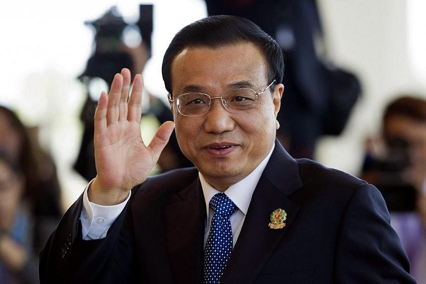 China's Prime Minister Li Keqiang waves as he arrives to take part in the 9th East Asia Summit (ESA) Plenary Session in Myanmar's capital Naypyidaw on Nov 13, 2014.&nbsp;China's Prime Minister Li Keqiang proposed a "friendship" treaty with Southeast 