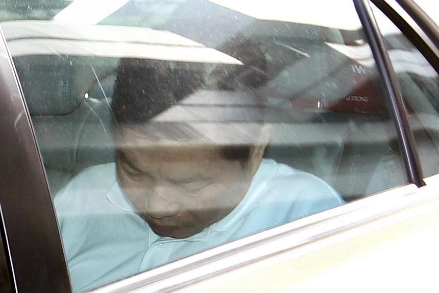 Chia Kee Chen in a car outside the Subordinate Courts on Jan 2, 2014. Chia, who is facing a murder charge of killing a raw materials planner in Choa Chu Kang last December, had another charge slapped on him on Thursday - conspiring with two others to