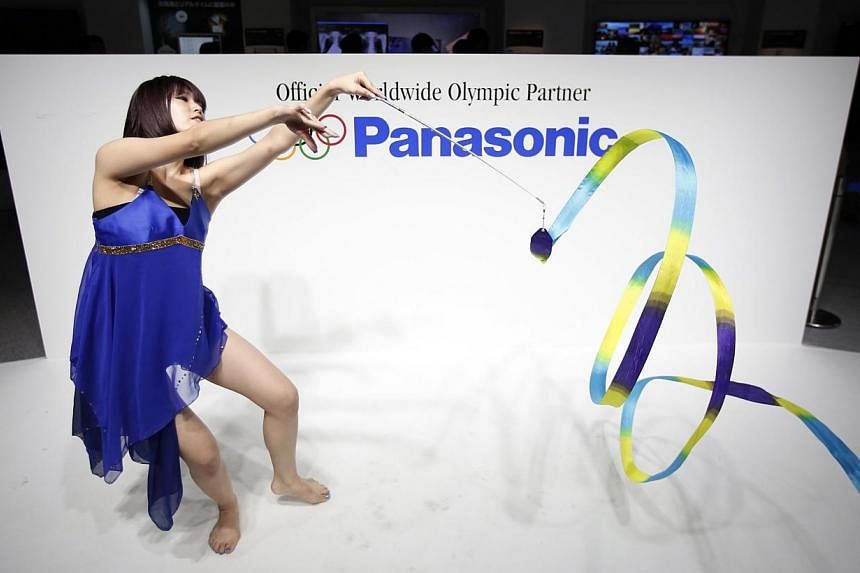 A woman performs rhythmic gymnastics with a ribbon at the Panasonic Corp booth at the Combined Exhibition of Advanced Technologies (CEATEC) JAPAN 2014 in Chiba, east of Tokyo on Oct 7, 2014.&nbsp;Panasonic is recalling more than 300,000 rechargeable 