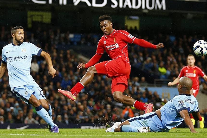Liverpool's Daniel Sturridge (centre) is challenged by Manchester City's Gael Clichy (left) and Vincent Kompany during their English Premier League soccer match at the Etihad stadium in Manchester, northern England Aug 25, 2014. Sturridge said Wednes