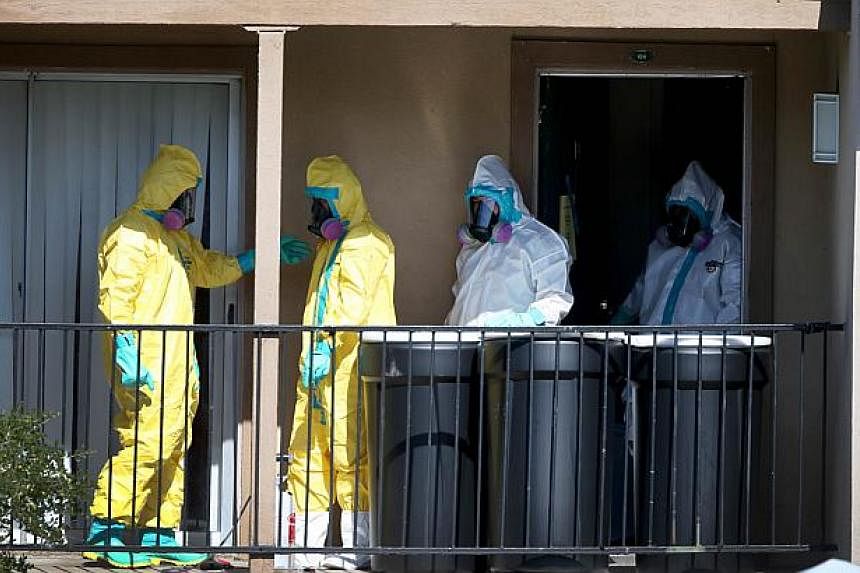 Hazmat workers sanitise the apartment where Ebola patient Thomas Eric Duncan was staying before being admitted to a hospital on Oct 5, 2014 in Dallas, Texas.&nbsp;The family of Thomas Eric Duncan, the first person to die of Ebola in the United States