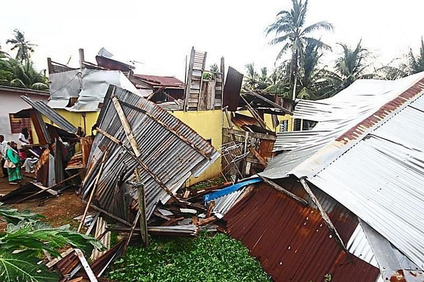 Scene of disaster: One of the houses in Kampung Sungai Nonang badly damaged after it was hit by a mini tornado on Wednesday. -- PHOTO: THE STAR/ASIA NEWS NETWORK