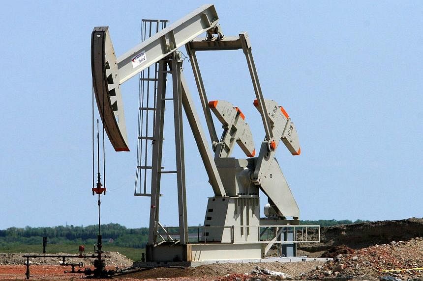Fall in oil prices to lowest levels in more than three years should give boost to sagging world economy, says IMF. -- PHOTO: AFP