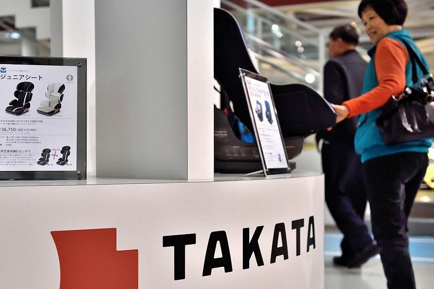 &nbsp;A photo taken on Nov 11, 2014 shows Japanese auto parts maker Takata's accessories on display at a car showroom in Tokyo. -- PHOTO: AFP&nbsp;
