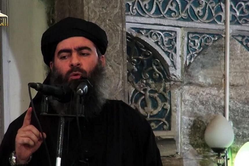 An image grab taken from a propaganda video released on July 5, 2014 by al-Furqan Media allegedly shows the leader of the Islamic State (IS) jihadist group, Abu Bakr al-Baghdadi, addressing worshippers at a mosque in the militant-held northern Iraqi 