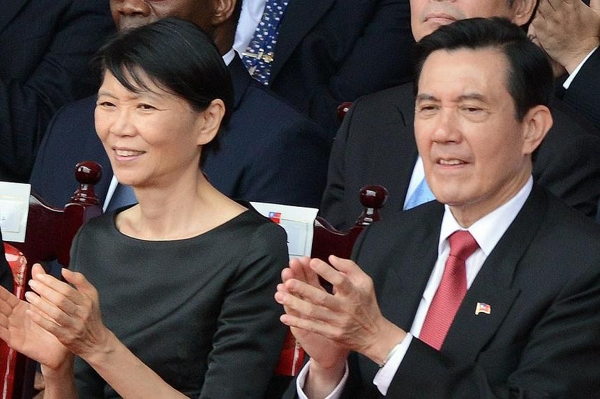 Taiwan President Ma Ying-jeou (right) and his wife Chow Mei-ching applaud during the national day anniversary in front of the Presidential Palace in Taipei on Oct 10, 2014. -- PHOTO: REUTERS