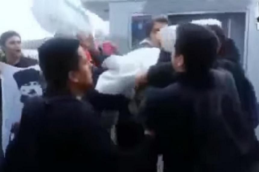 A screenshot from YouTube showing the attack on three US sailors by members of the nationalist Turkish Youth Union on a crowded street in Istanbul on Wednesday. Turkey's Foreign Minister on Friday described an assault on US sailors in Istanbul this w