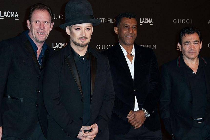 Recording artist Boy George (second left) and members of the band Culture Club arrive at an event honoring film director Quentin Tarantino and artist Barbara Kruger in Los Angeles on Nov 1, 2014. Boy George on Thursday called off a reunion tour of 19