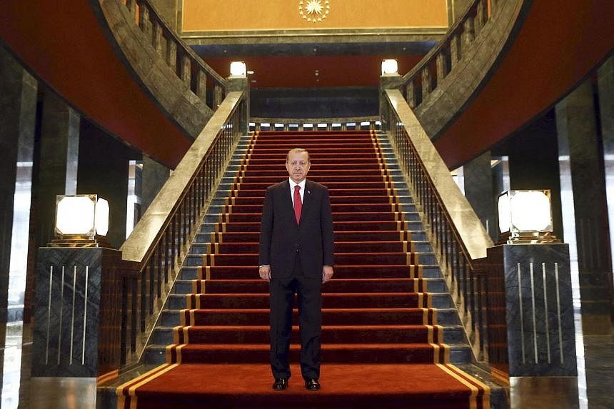 Turkish President Recep Tayyip Erdogan poses inside the new Ak Saray presidential palace (White Palace) on the outskirts of Ankara on Oct 29, 2014.&nbsp;Erdogan is planning to expand his already controversial new presidential palace with a 250-room r