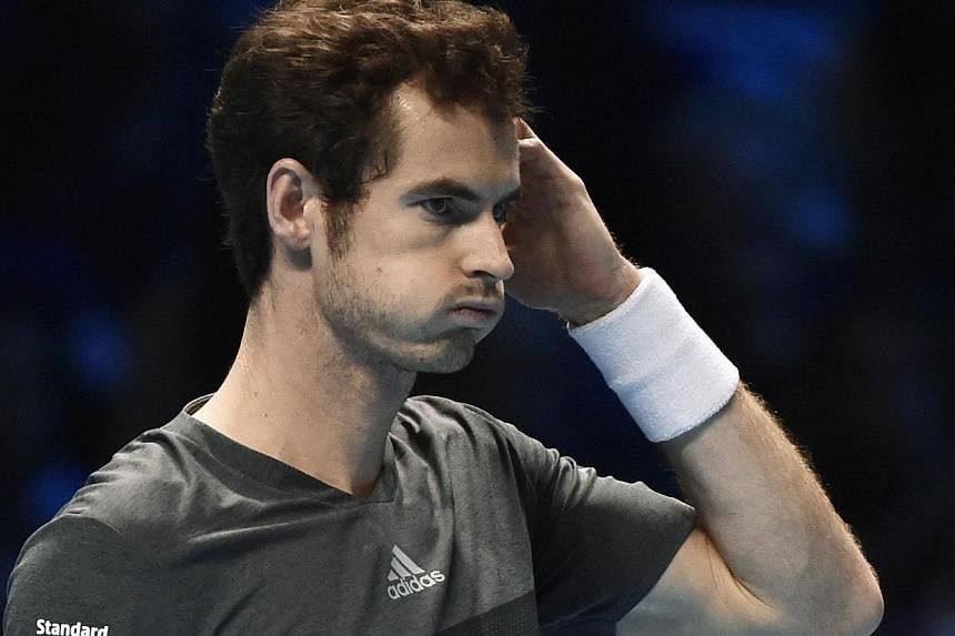 Andy Murray of Britain reacts during his tennis match against Roger Federer of Switzerland at the ATP World Tour finals at the O2 Arena in London Nov 13, 2014. Roger Federer allowed Andy Murray only eight points in a 6-0 first set in their ATP World 