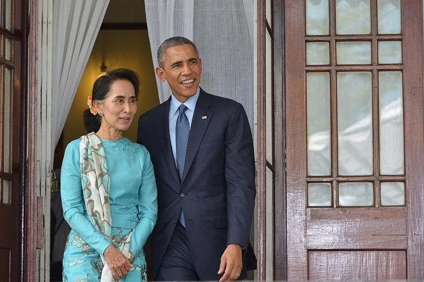 US President Barack Obama and Myanmar's opposition leader Aung San Suu Kyi speak during a press conference at her residence in Yangon on Nov 14, 2014. -- PHOTO: AFP
