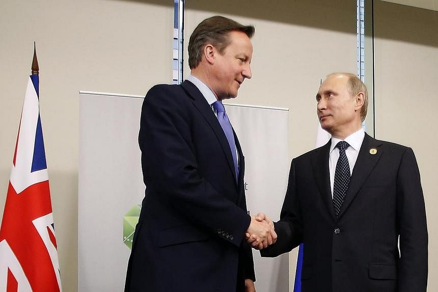 British Prime Minister David Cameron (left) shakes hands with Russian President Vladimir Putin during their bilateral meeting on the side of the G20 leaders summit in Brisbane on Nov 15, 2014.&nbsp;Russian President Vladimir Putin and British Prime M