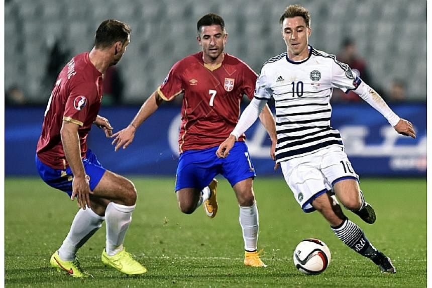Denmark's midfielder Christian Eriksen (right) vies for the ball with Serbia's striker Zoran Tosic (centre) and Serbia's defender Branislav Ivanovic (left) during the Euro 2016 group I qualifying football match between Serbia and Denmark in Belgrade 