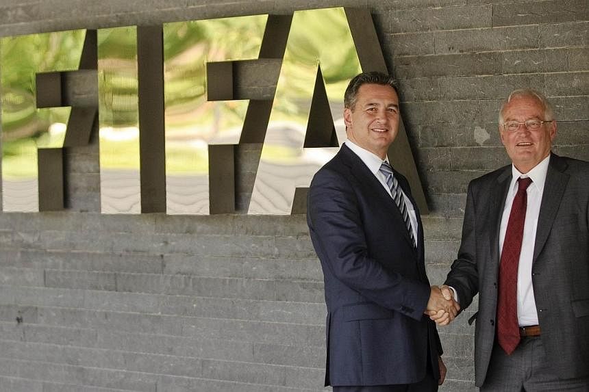 Mr Michael J Garcia (left), Chairman of the investigatory chamber of the Fifa Ethics Committee, and Mr Hans-Joachim Eckert, Chairman of the adjudicatory chamber of the Fifa Ethics Committee posing for photographers after a press conference at Fifa he