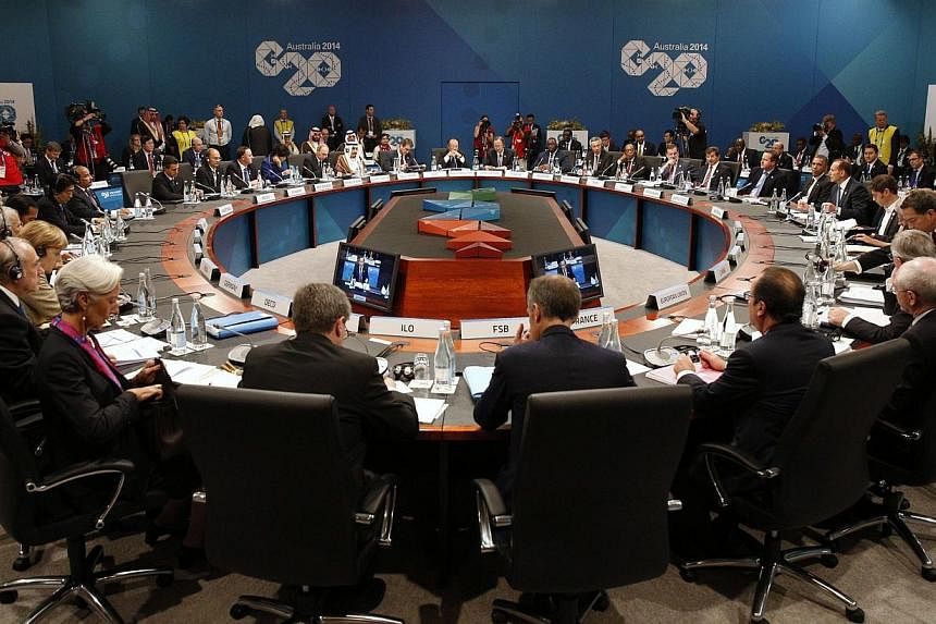Leaders meet at the first plenary session at the G20 summit in Brisbane on Nov 15, 2014.&nbsp;&nbsp;Leaders of the world's most powerful economies on Saturday vowed to do all they can to "extinguish" the deadly Ebola outbreak in west Africa. -- PHOTO