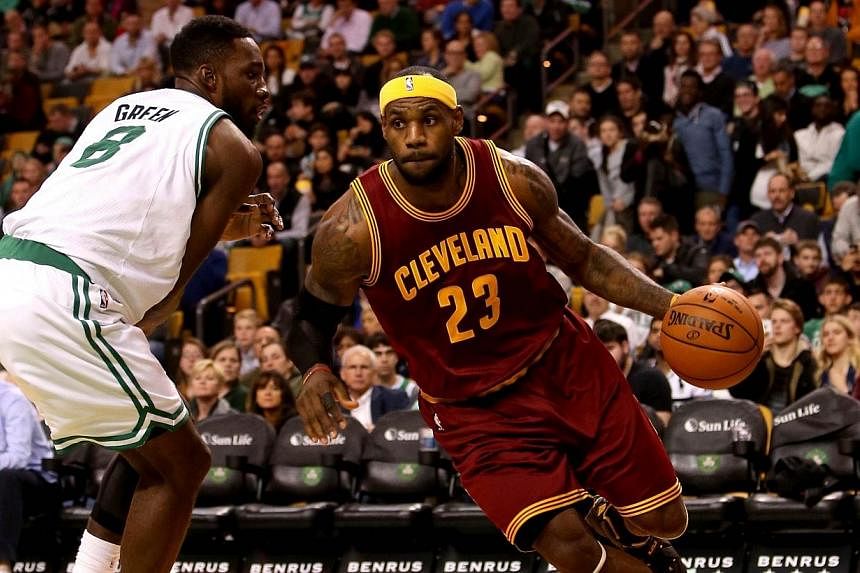 LeBron James of the Cleveland Cavaliers drives with the ball against Jeff Green of the Boston Celtics in the second half at TD Garden on Nov 14, 2014, in Boston, Massachusetts.&nbsp;-- PHOTO: AFP