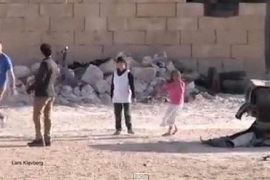 A viral video showing a Syrian boy rescuing a girl under gunfire, watched online by millions of viewers, was faked by a Norwegian film crew, the BBC reported. -- PHOTO: SCREENGRAB FROM YOUTUBE