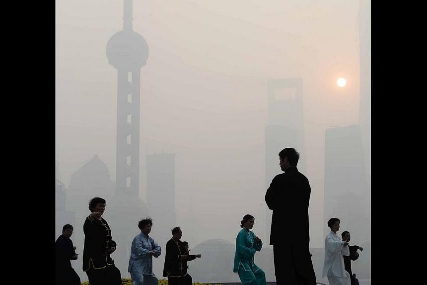 Residents exercising outdoors despite heavy smog in Shanghai on Wednesday. A recent report found that the health and mortality burden of air pollution in China accounts for more than 10 per cent of GDP.