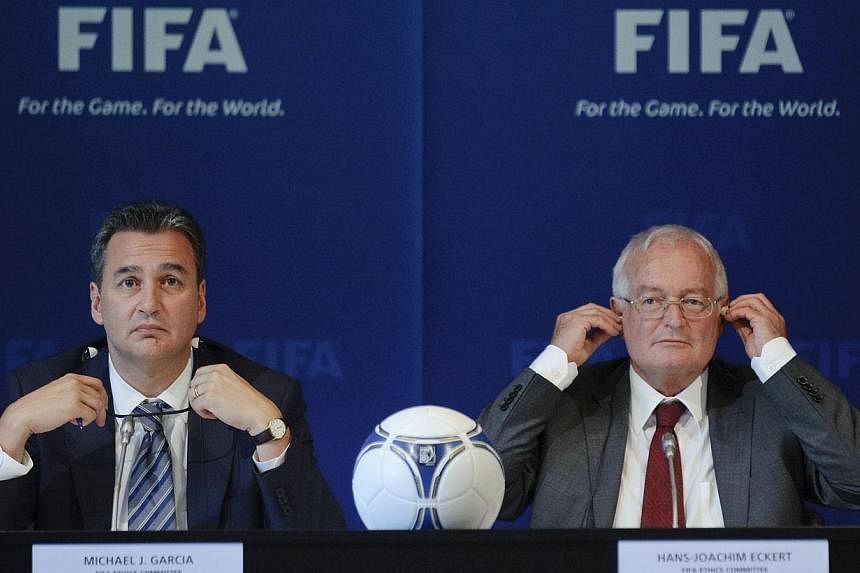 A July 27, 2012 photo shows Michael Garcia (left), Chairman of the investigatory chamber of the FIFA Ethics Committee, and Hans-Joachim Eckert (right), Chairman of the adjudicatory chamber of the FIFA Ethics Committee taking part in a press conferenc