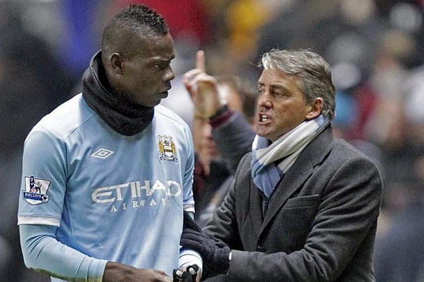 Inter Milan reappointed Roberto Mancini (seen here in a 2010 file photo with striker Mario Balotelli)&nbsp;as coach on Friday in a bid to rediscover their glory days when they won three successive Serie A titles under the Italian. -- PHOTO: AFP