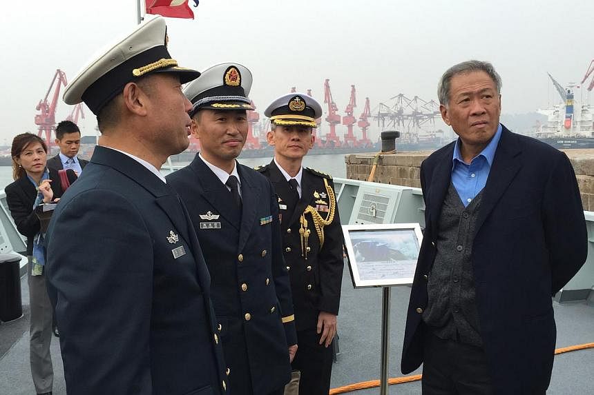 Defence Minister Ng Eng Hen (right) toured the PLA Navy's newest missile corvette Fushun at the Qingdao naval base, which is the headquarters for the PLA Navy's North Sea Fleet. -- PHOTO: ST FILE