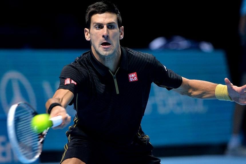 Novak Djokovic (above) was at his imperious best as he sealed the year-end world number one spot and advanced to the semi-finals of the ATP Tour Finals with a 6-2, 6-2 thrashing of Tomas Berdych on Friday.&nbsp;-- PHOTO: AFP&nbsp;