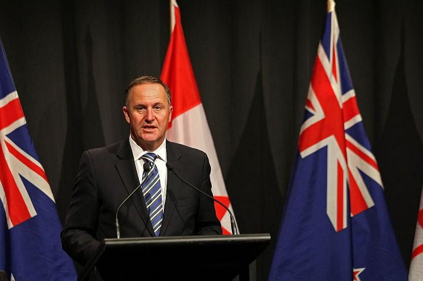 New Zealand's Prime Minister John Key speaks at a joint press conference with Canada's prime minister in Auckland on Nov 14, 2014. -- PHOTO: AFP