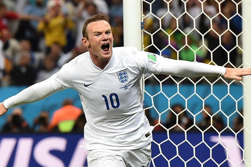 A file picture taken on June 19, 2014 shows England forward Wayne Rooney celebrating a goal during the 2014 Fifa World Cup.&nbsp;Rooney deserves to be thought of as an England great, national team manager Roy Hodgson said on Friday.&nbsp;-- PHOTO: AF