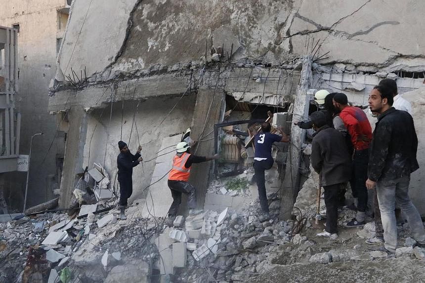 Civilians and Civil Defence members work at a site hit by airstrikes allegedly by forces loyal to Syria's President Bashar al-Assad in Raqqa, Syria, which is controlled by the Islamic State in Iraq and Syria (ISIS) on Nov 11, 2014.&nbsp;US President 
