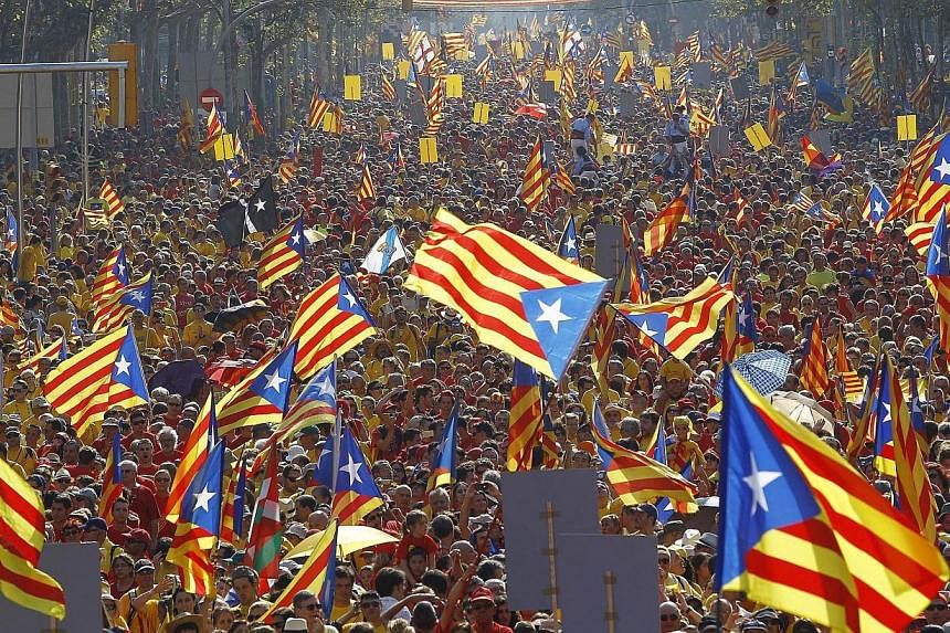 Catalans holding independentist flags (Estelada) and gathering on Gran Via de les Corts Catalanes during celebrations of Catalonia National Day (Diada) in Barcelona in September. In one of the few incidents reported, police arrested five people for d
