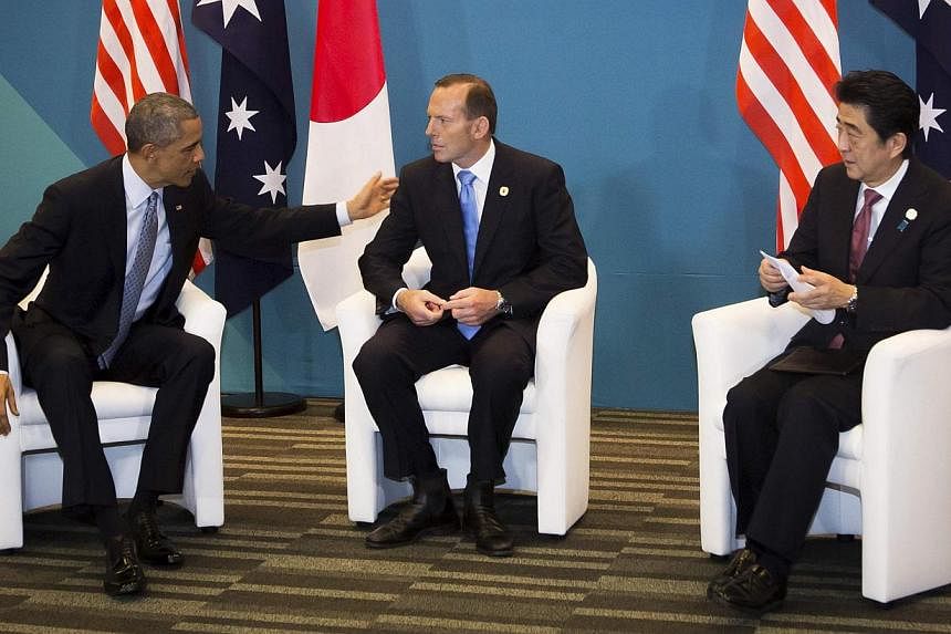 US President Barack Obama (left) meets with Australia's Prime Minister Tony Abbott, and Japan's Prime Minister Shinzo Abe during a trilateral meeting at the G20 conference in Brisbane, on Nov 16, 2014. -- PHOTO: REUTERS