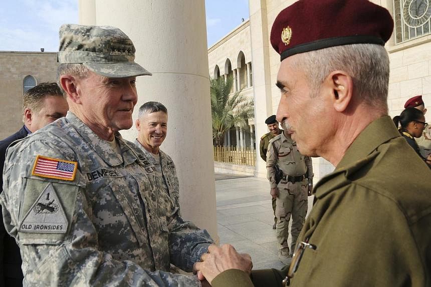 Iraq's army chief, Lieutenant-General Babakir Zebari (right) meets US Army General Martin Dempsey, chairman of the Joint Chiefs of Staff, at the defence ministry in Baghdad Nov 15, 2014. Dempsey arrived on Saturday in Baghdad on an unannounced visit 