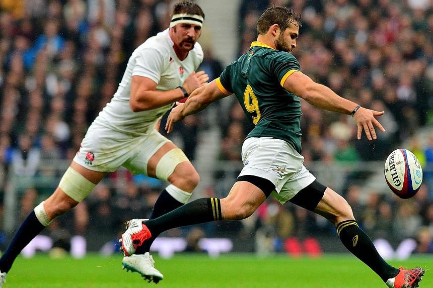 South Africa's scrum half Cobus Reinach (right) clears the ball from a scrum during the Autumn International rugby union Test match between England and South Africa at Twickenham Stadium, south-west of London on Nov 15, 2014. South Africa returned to
