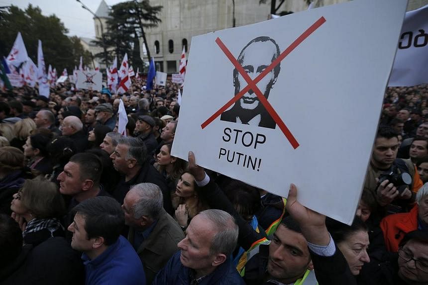 People attend an opposition rally to protest against Russia's policy towards Georgia and Ukraine in Tbilisi, Nov 15, 2014. -- PHOTO: REUTERS