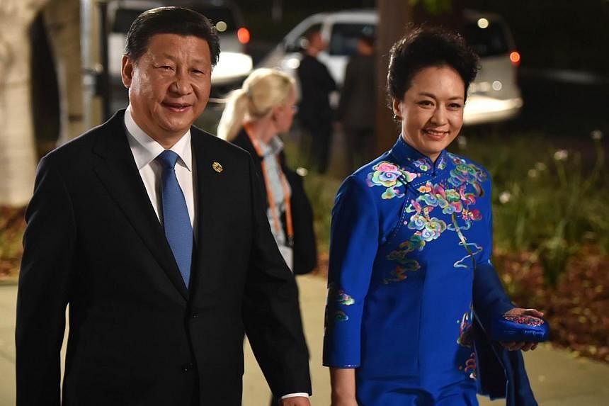 China's President Xi Jinping and his wife Peng Liyuan arrive at the Gallery of Modern Art in Brisbane as he takes part in the G-20 Summit on Nov 15, 2014. President Xi said on Saturday China's economy will maintain strong, sustainable and balanced gr