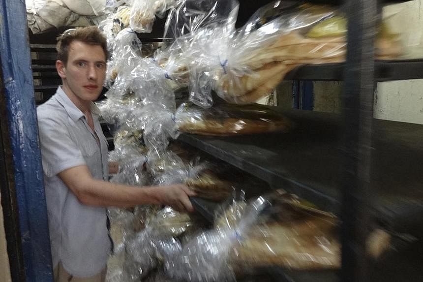 Abdul-Rahman (Peter) Kassig is pictured collecting bread for a delivery to refugee populations in this undated handout photo.&nbsp;A man said on Monday, Nov 17, 2014, that he believed his son, a British medical student, was among a squad of Islamic S