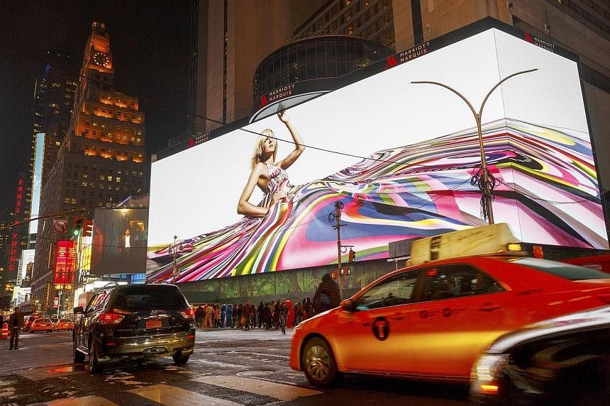 The world's largest high-definition digital display lights up for the first time in Times Square in New York on Nov 13, 2014. -- PHOTO: NYT