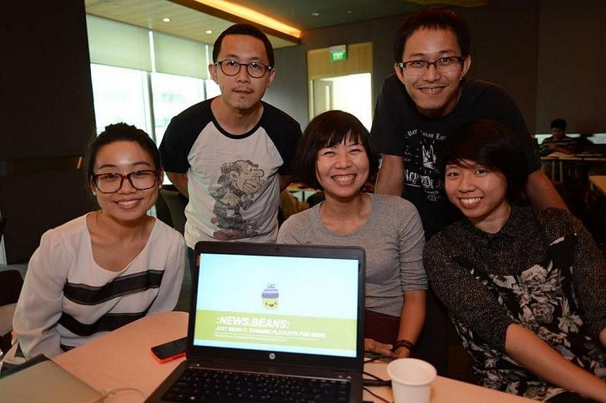 The five-member team, including team leader Lim Huishan (middle) from Singapore Press Holdings that won the top prize at a digital media hackathon on Sunday for their personalised news app "Beans". -- PHOTO: SPH