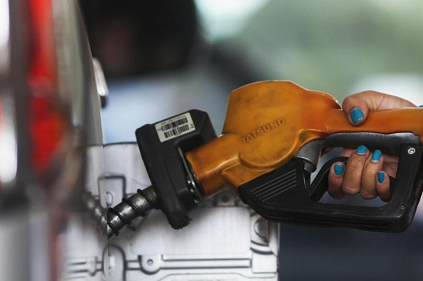 A worker at state-owned Pertamina, the country's main retailer of subsidised fuel, fills a vehicle at a petrol station in Jakarta on Nov 17, 2014.&nbsp;Indonesia is likely to announce a rise in subsidised prices of gasoline and diesel late on Monday,