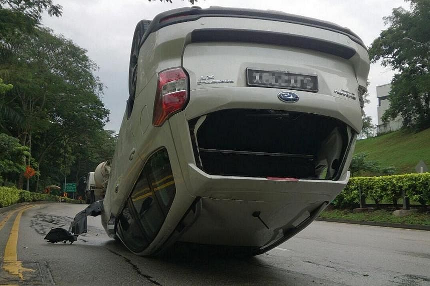 A car was found overturned on Ulu Pandan Road on Monday afternoon. -- ST PHOTO: DESMOND FOO&nbsp;