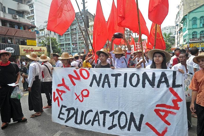 Dozens of university students march in a protest against the proposed national education bill in Yangon on Nov 17, 2014.&nbsp;Scores of Myanmar students rallied illegally in Yangon on Monday, Nov 17, against a new education bill they describe as unde