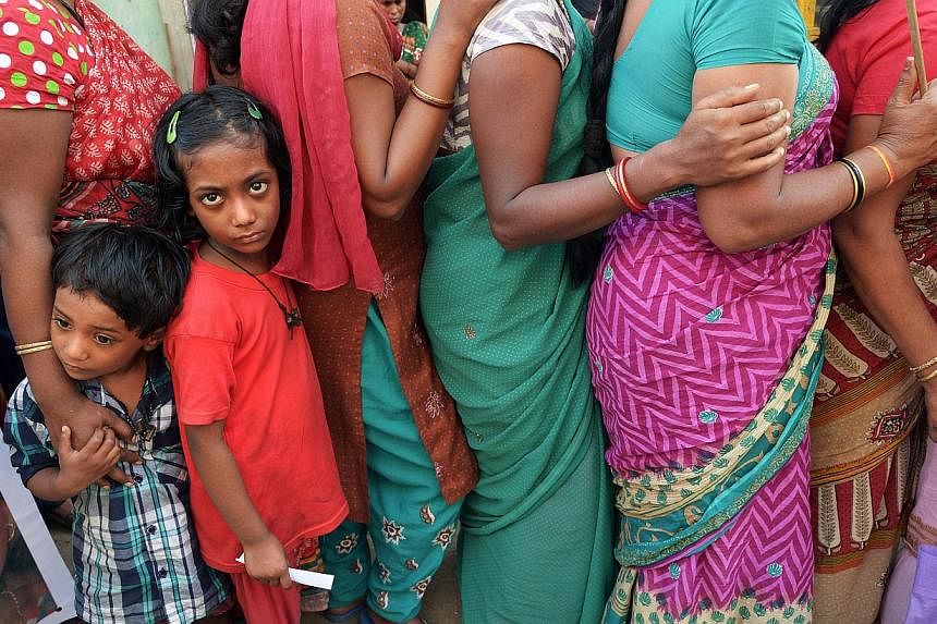 The children of Indian sex workers look on as they participate in a rally at the Sonagachi area of Kolkata on Nov 8, 2014.&nbsp;Forced to pick cotton, grow cannabis, prostitute themselves, fight wars or clean up after the wealthy - some 35.8 million 
