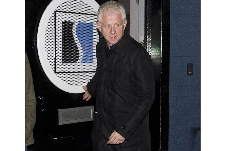 New Zealand-born British screenwriter Richard Curtis leaves a west London studio after helping to record the new Band Aid 30 single on Nov 15, 2014. -- PHOTO: AFP