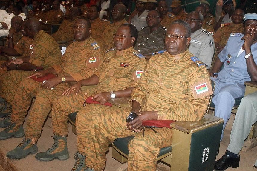 Burkina Faso's military leaders sit during a signature of a transition charter at the Maison du Peuple in Ouagadougou on Nov 16, 2014. -- PHOTO: AFP&nbsp;