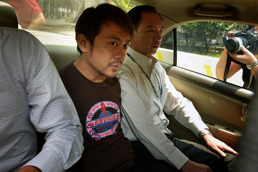 Mr Yang Yin in a police car on Nov 5, 2014. -- PHOTO: ST FILE