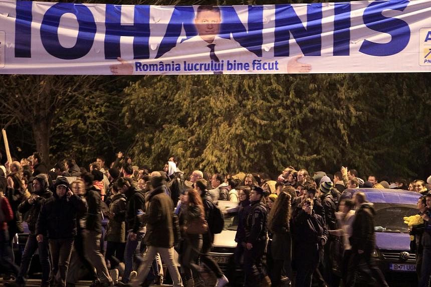 A campaign banner of presidential candidate Klaus Iohannis near government headquarters in Bucharest on Nov 16, 2014. -- PHOTO: REUTERS