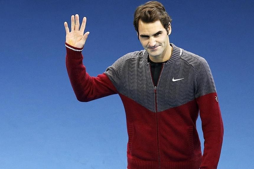 "I'm sorry I'm here in a tracksuit. I wish it weren't so," said Roger Federer as he announced his withdrawal from the ATP Tour Final at London's O2 Arena on Sunday, Nov 16, 2014. -- PHOTO: REUTERS