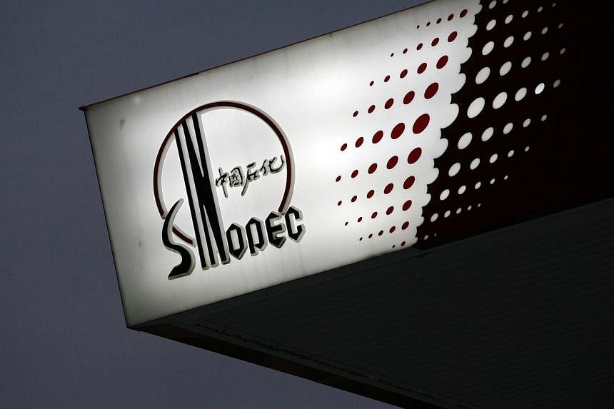 A Sinopec logo is seen at one of its gas stations in Hong Kong on April 26, 2010. -- PHOTO: REUTERS