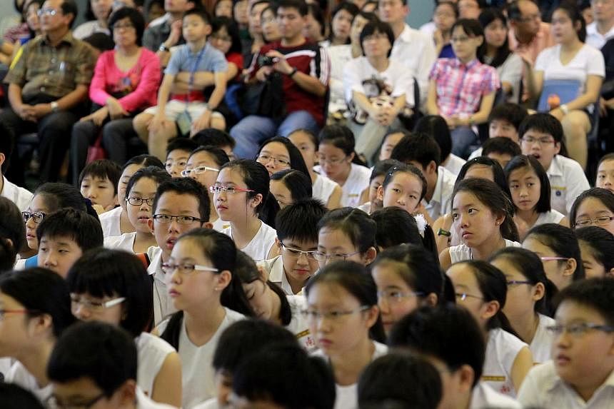 Pupils and parents awaiting the results of the 2012 Primary School Leaving Examination (PSLE) at Nanyang Primary School. The results of the 2014 PSLE will be released on this Friday, says the Ministry of Education. -- PHOTO: ST FILE&nbsp;