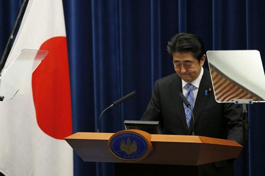 Japan's Prime Minister Shinzo Abe attends a news conference at his official residence in Tokyo on Nov 18, 2014.&nbsp;Japanese Prime Minister Shinzo Abe said on Tuesday he would delay a planned rise in the nation's sales tax to 10 per cent till April 